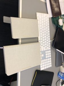 two notebooks next to a keyboard